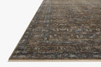 Vintage-style area rug with brown and blue tones, intricate floral pattern and distressed finish