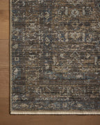 Vintage-style area rug with brown and blue tones, intricate floral pattern and distressed finish