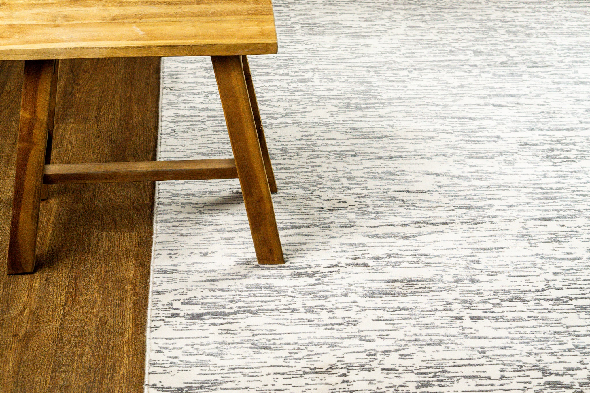 Gray and white textured area rug with linear woven pattern throughout