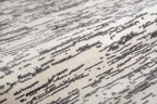 Gray and white textured area rug with linear woven pattern throughout