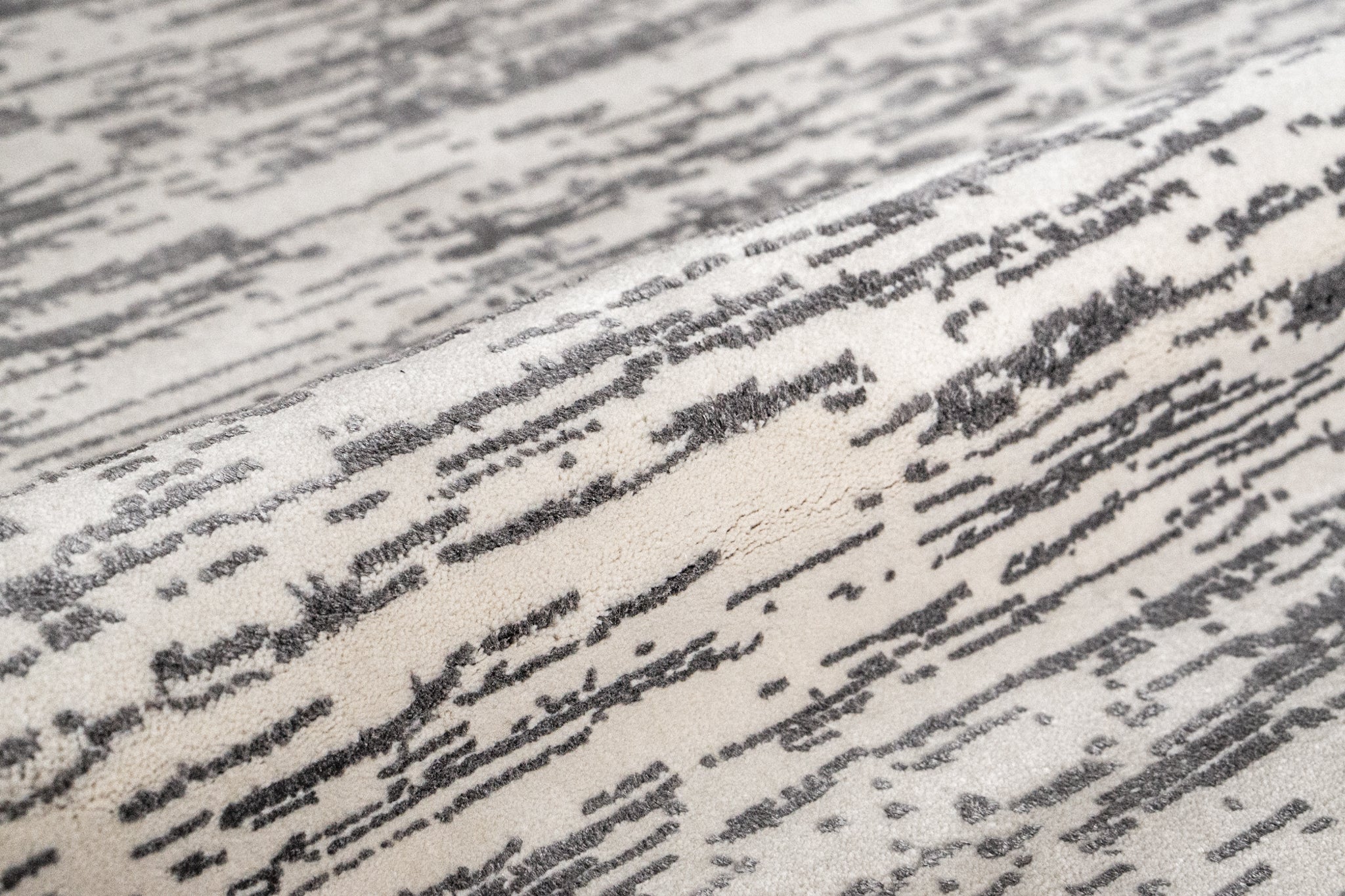 Gray and white textured area rug with linear woven pattern throughout