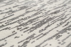 Gray and white textured area rug with linear woven pattern throughout
