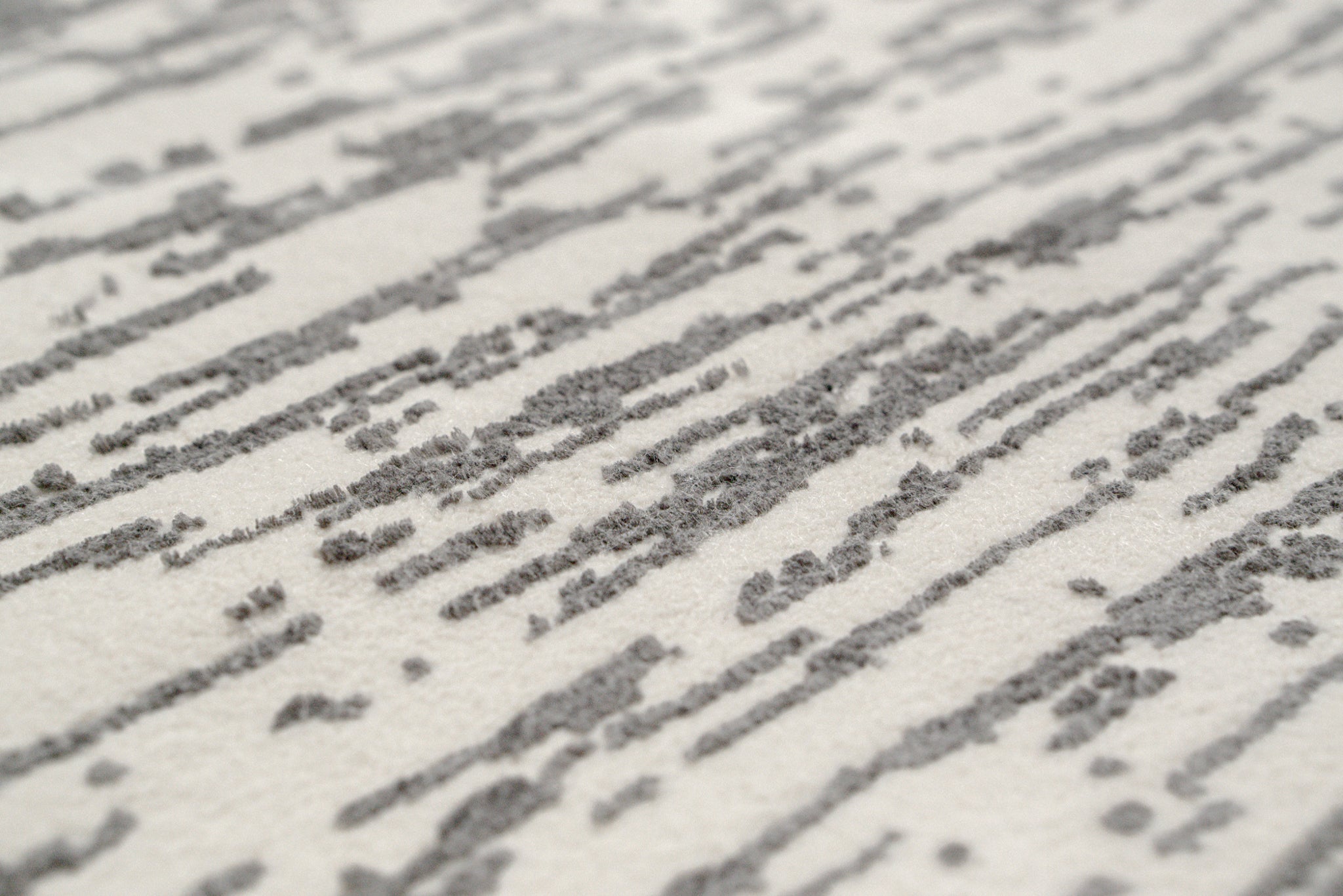 Gray and white textured area rug with linear woven pattern throughout