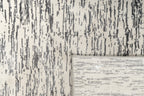 Gray and white textured area rug with linear woven pattern throughout