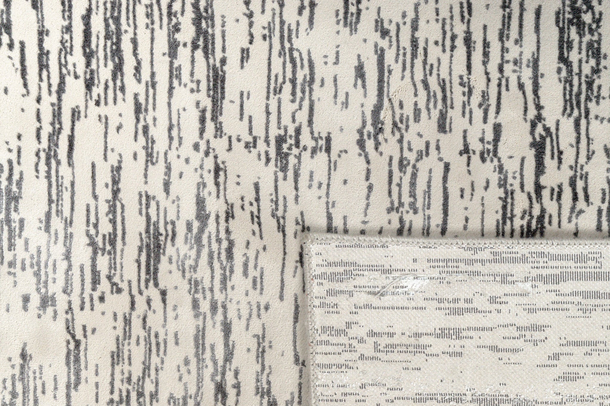 Gray and white textured area rug with linear woven pattern throughout