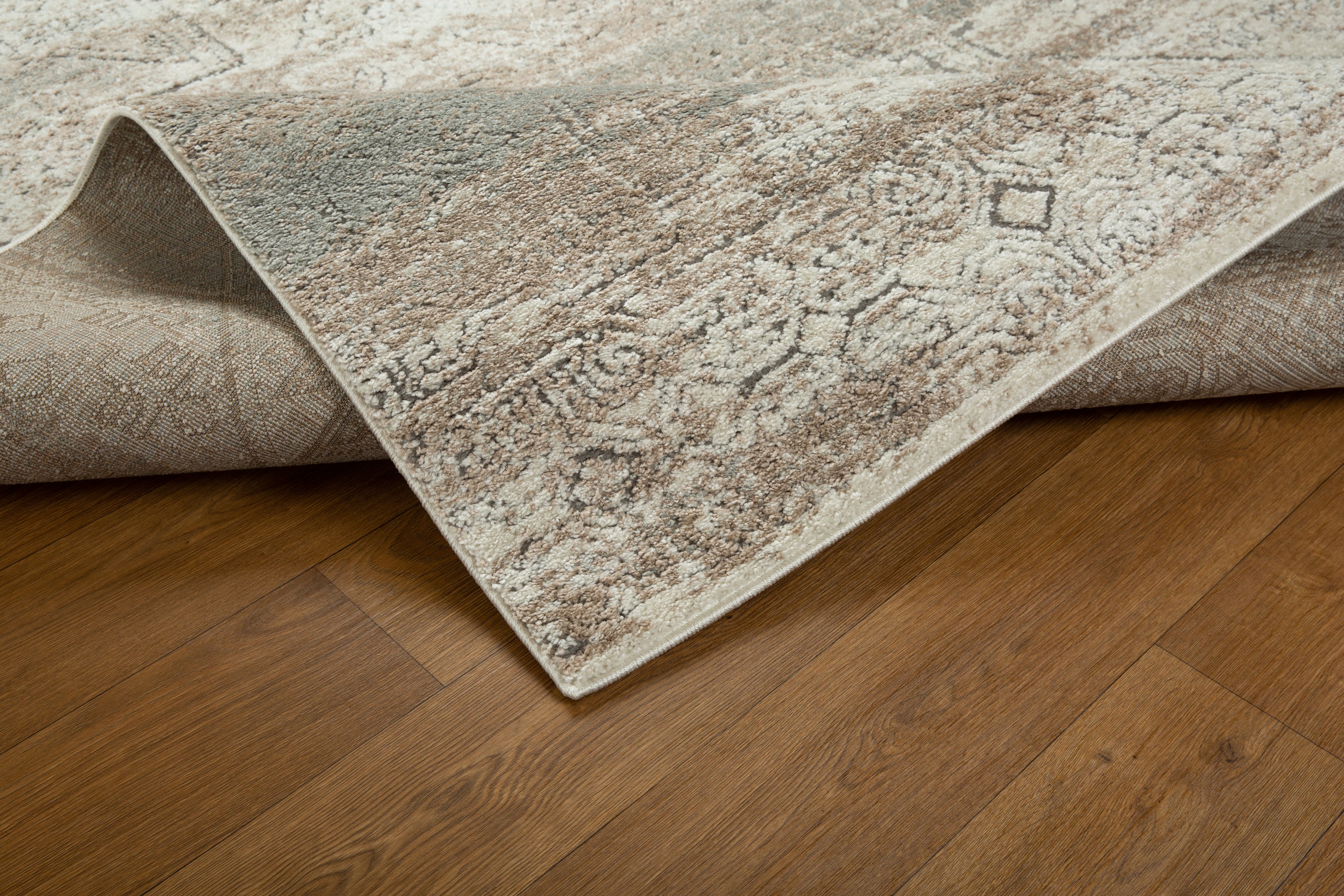 Vintage beige and grey distressed geometric patterned area rug with worn texture
