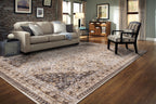 Vintage-style area rug with beige and brown geometric patterns and ornate borders