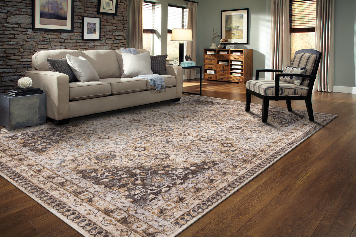 Vintage-style area rug with beige and brown geometric patterns and ornate borders