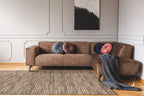 Brown textured area rug with horizontal woven pattern in natural tones