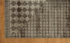 Brown and cream geometric patterned rug with textured weave design