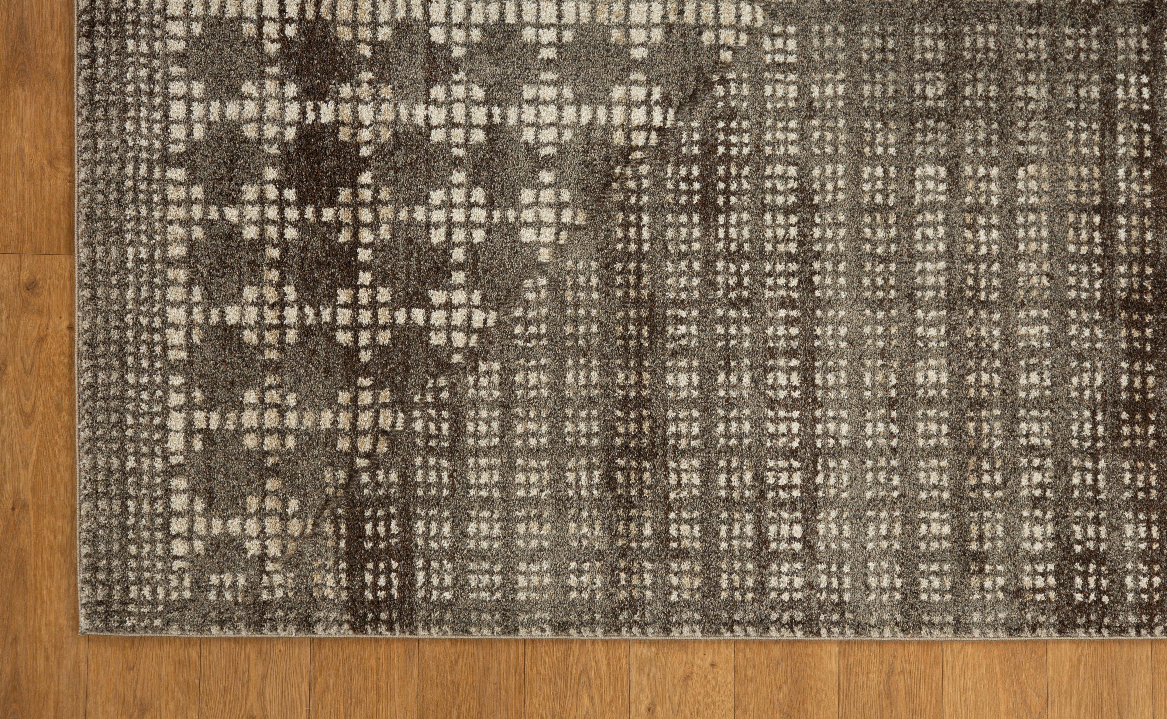 Brown and cream geometric patterned rug with textured weave design