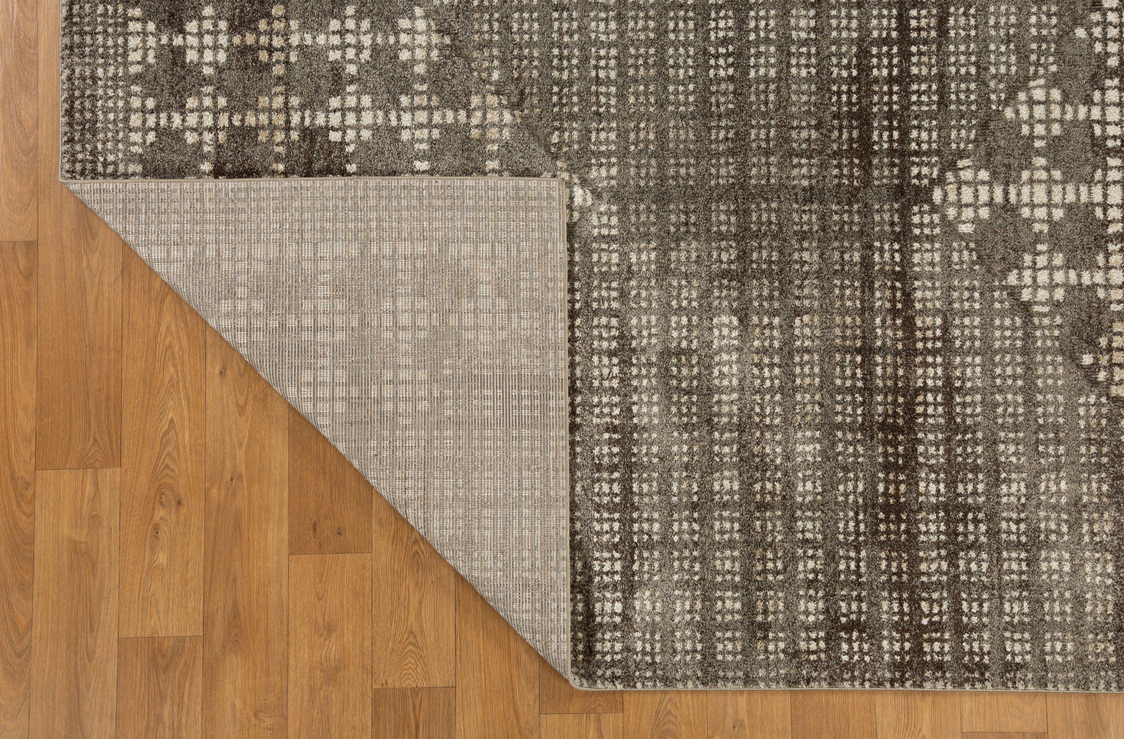 Brown and cream geometric patterned rug with textured weave design