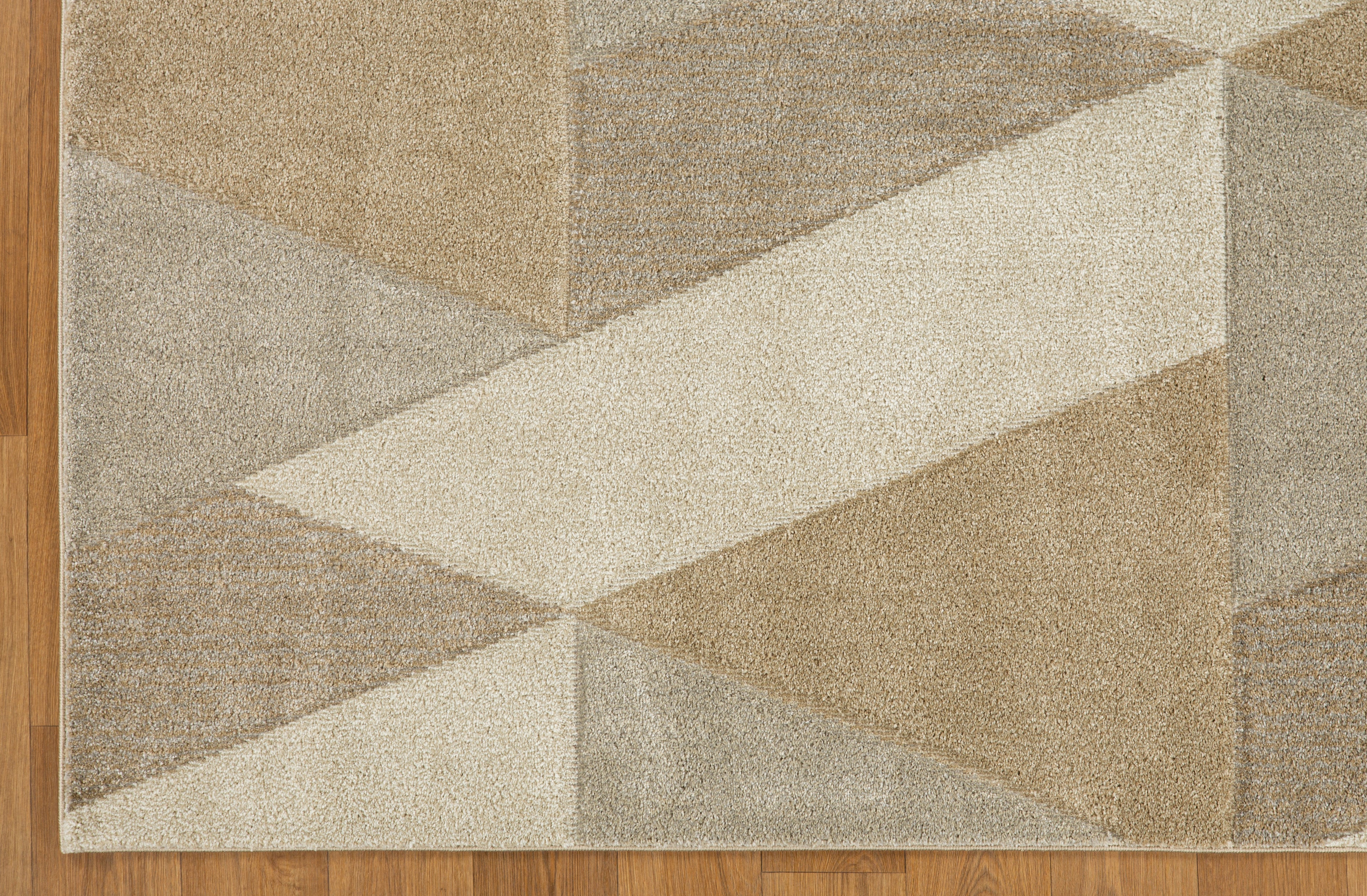 Geometric beige and cream triangle pattern rug with textured wool pile