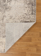 Modern abstract distressed rug with cream and charcoal gray textured pattern
