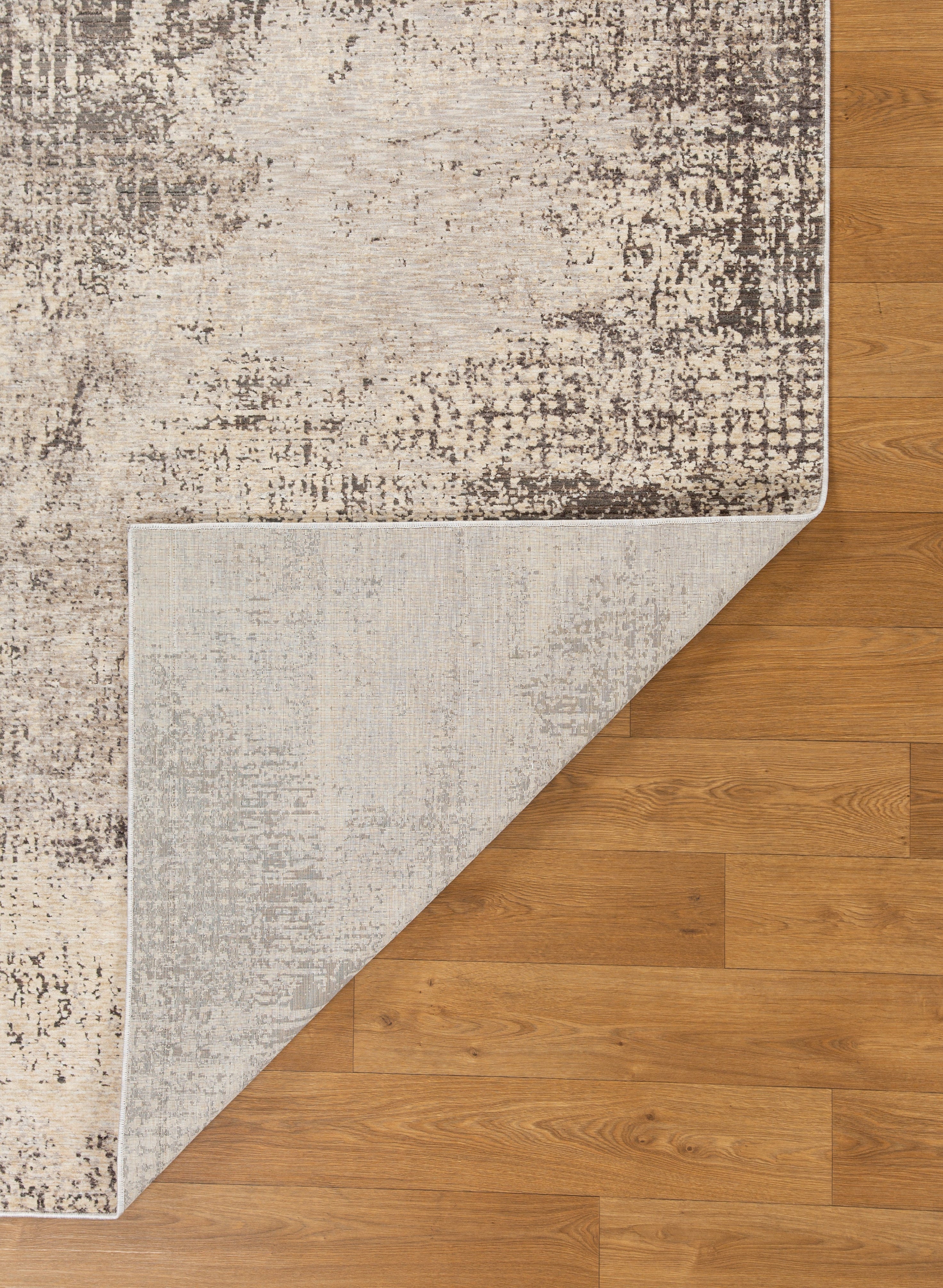 Modern abstract distressed rug with cream and charcoal gray textured pattern