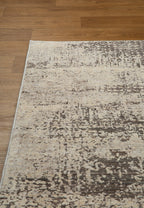 Modern abstract distressed rug with cream and charcoal gray textured pattern