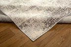 Modern abstract distressed rug with cream and charcoal gray textured pattern