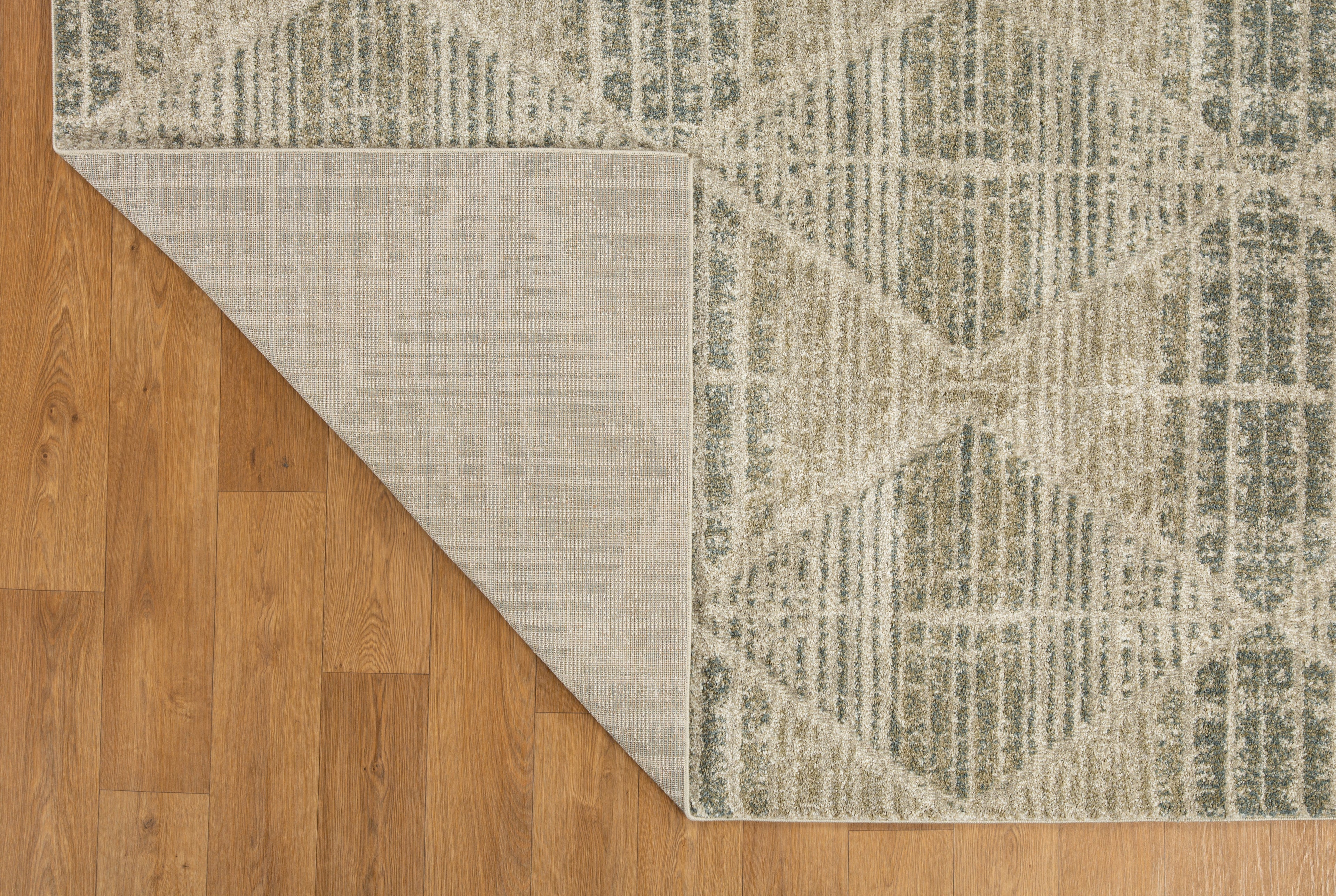 Neutral beige geometric patterned rug with textured woven appearance and diamond motifs