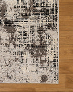 Modern distressed rug with abstract geometric pattern in cream and charcoal gray tones