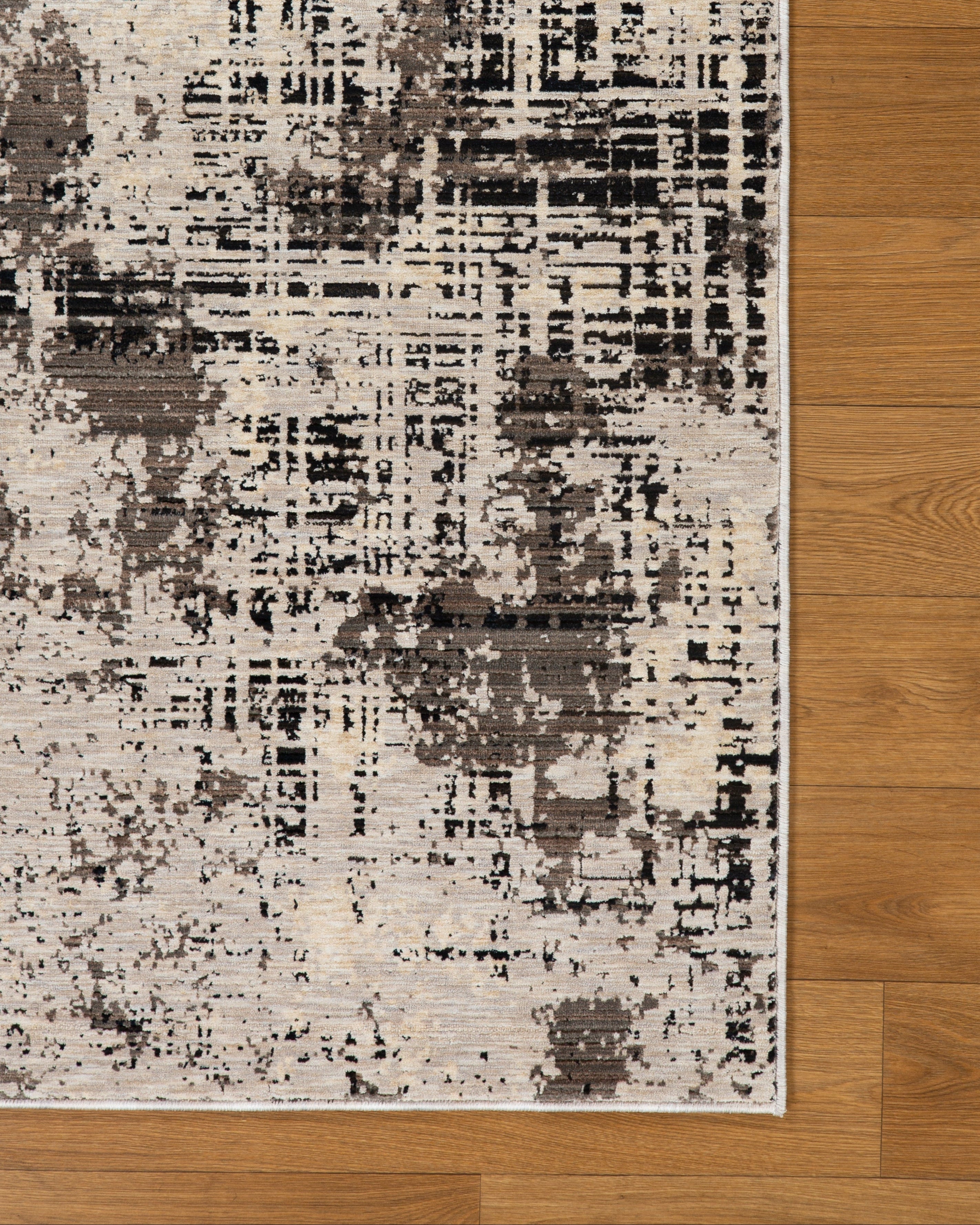 Modern distressed rug with abstract geometric pattern in cream and charcoal gray tones