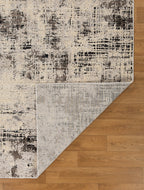 Modern distressed rug with abstract geometric pattern in cream and charcoal gray tones