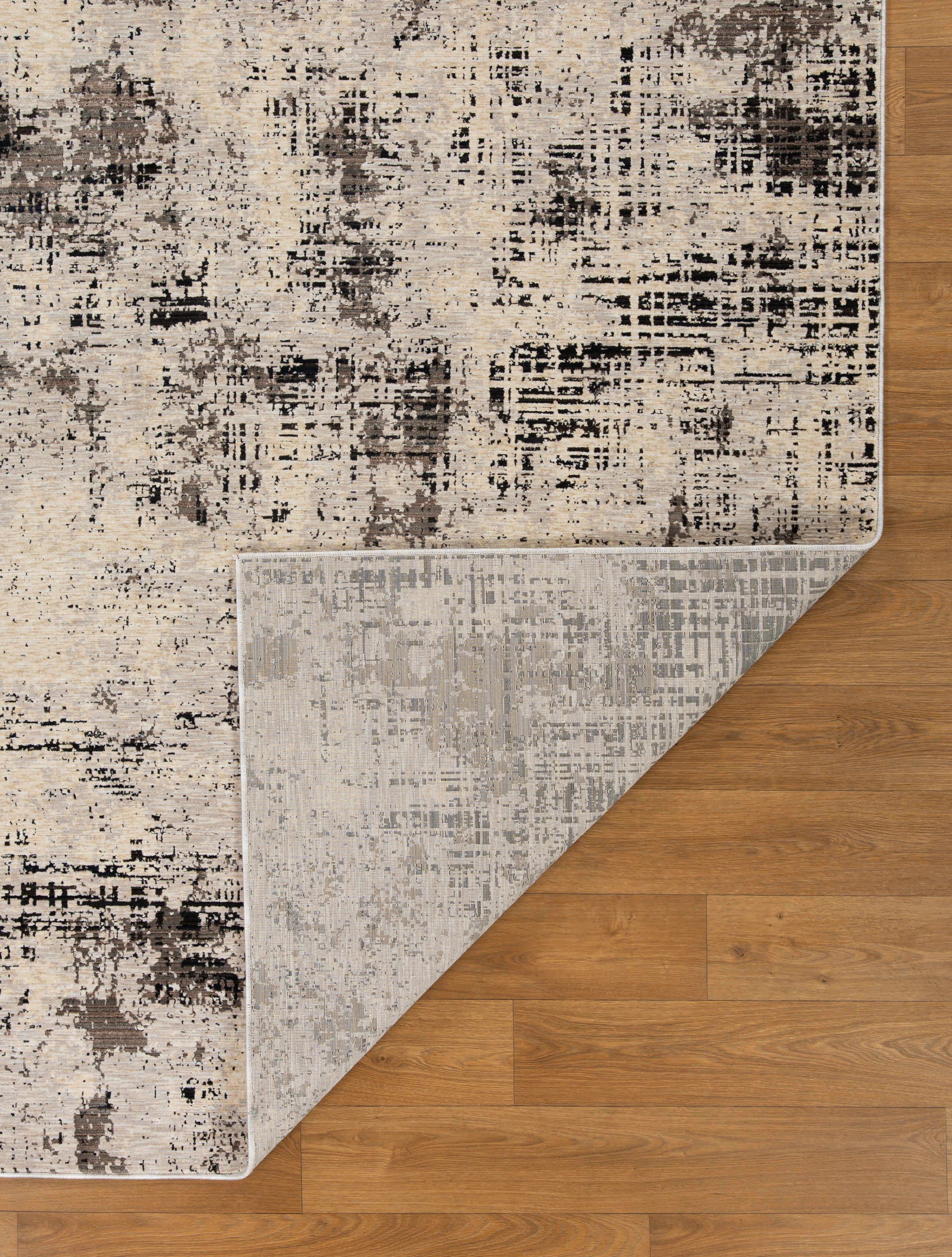 Modern distressed rug with abstract geometric pattern in cream and charcoal gray tones