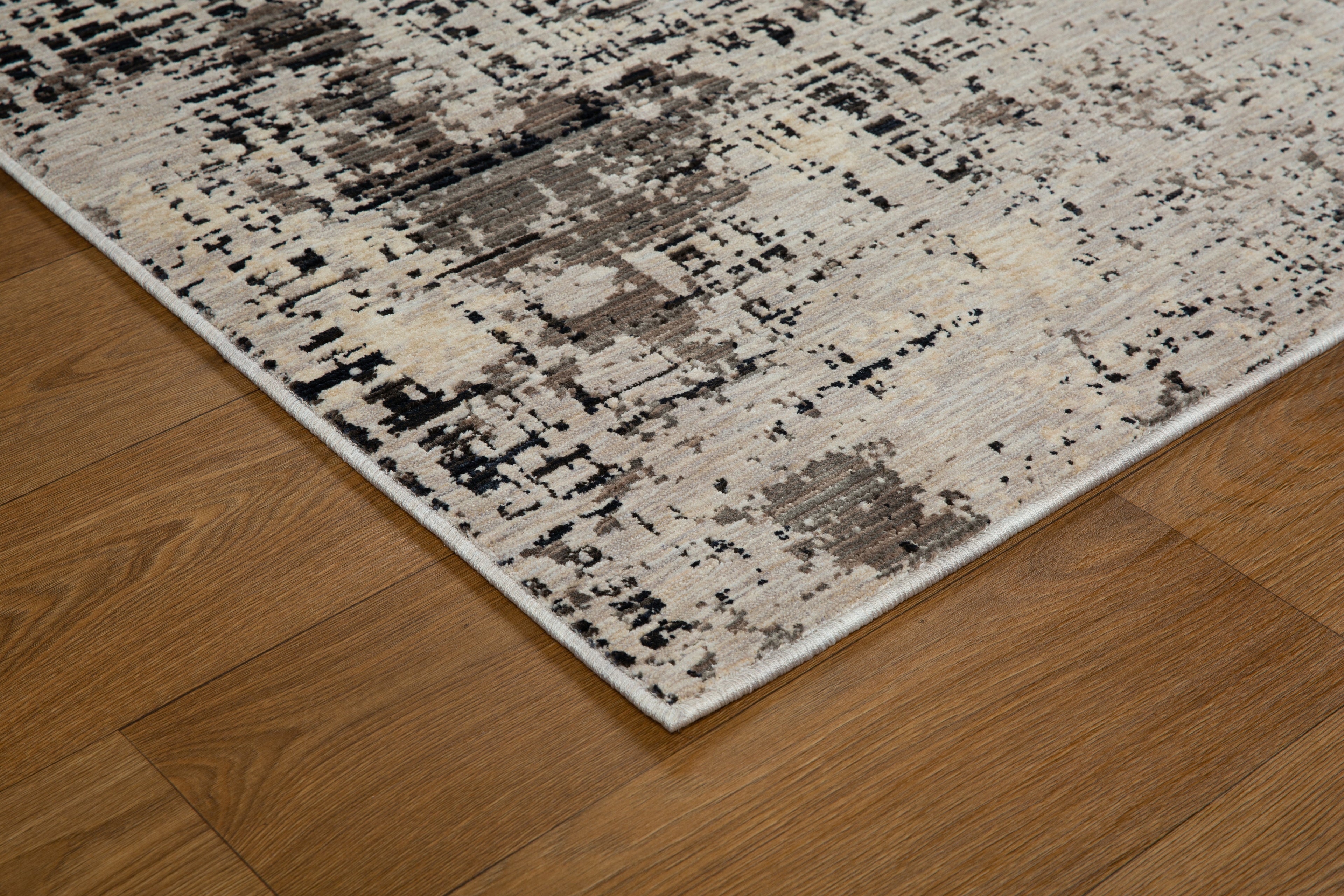 Modern distressed rug with abstract geometric pattern in cream and charcoal gray tones