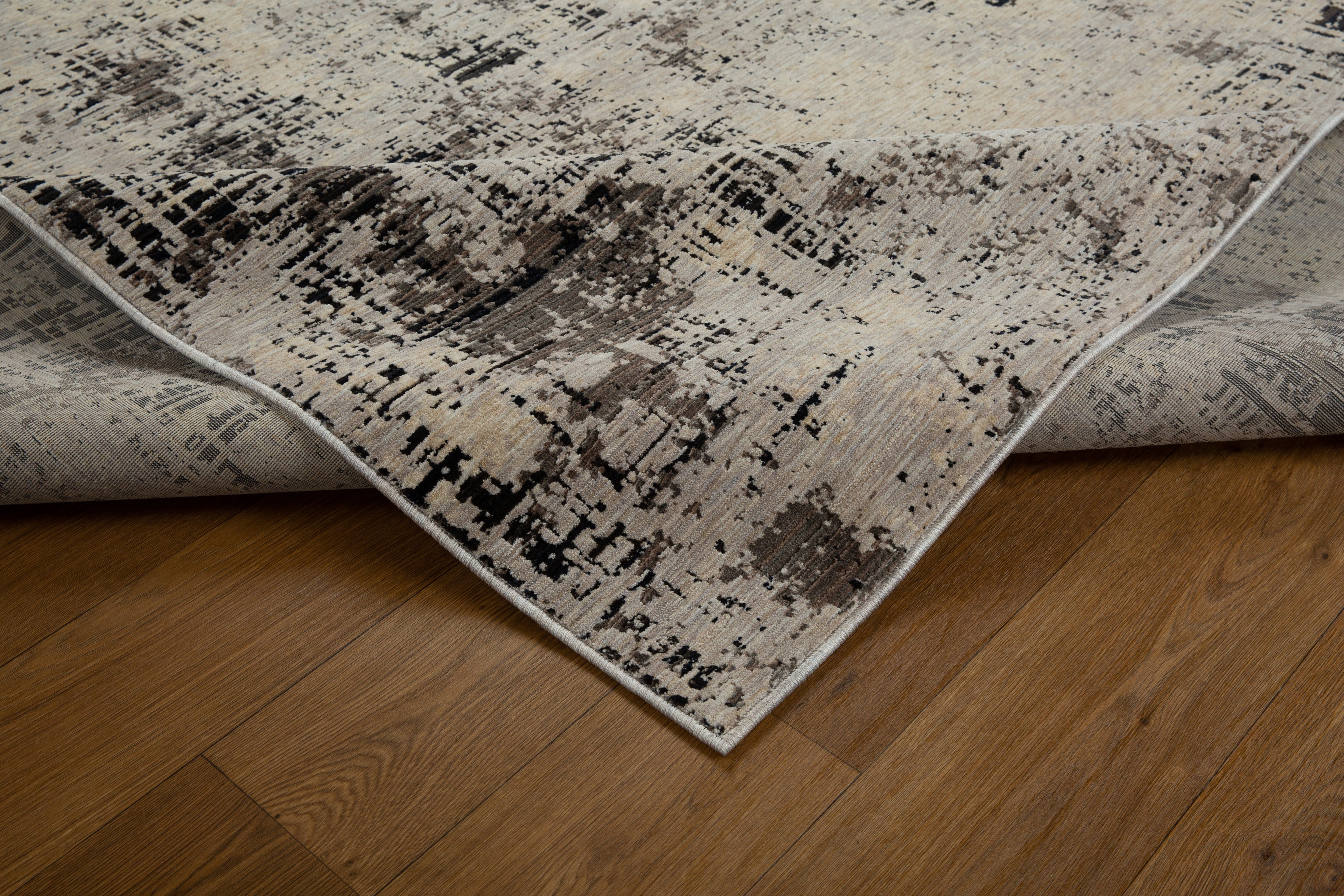Modern distressed rug with abstract geometric pattern in cream and charcoal gray tones
