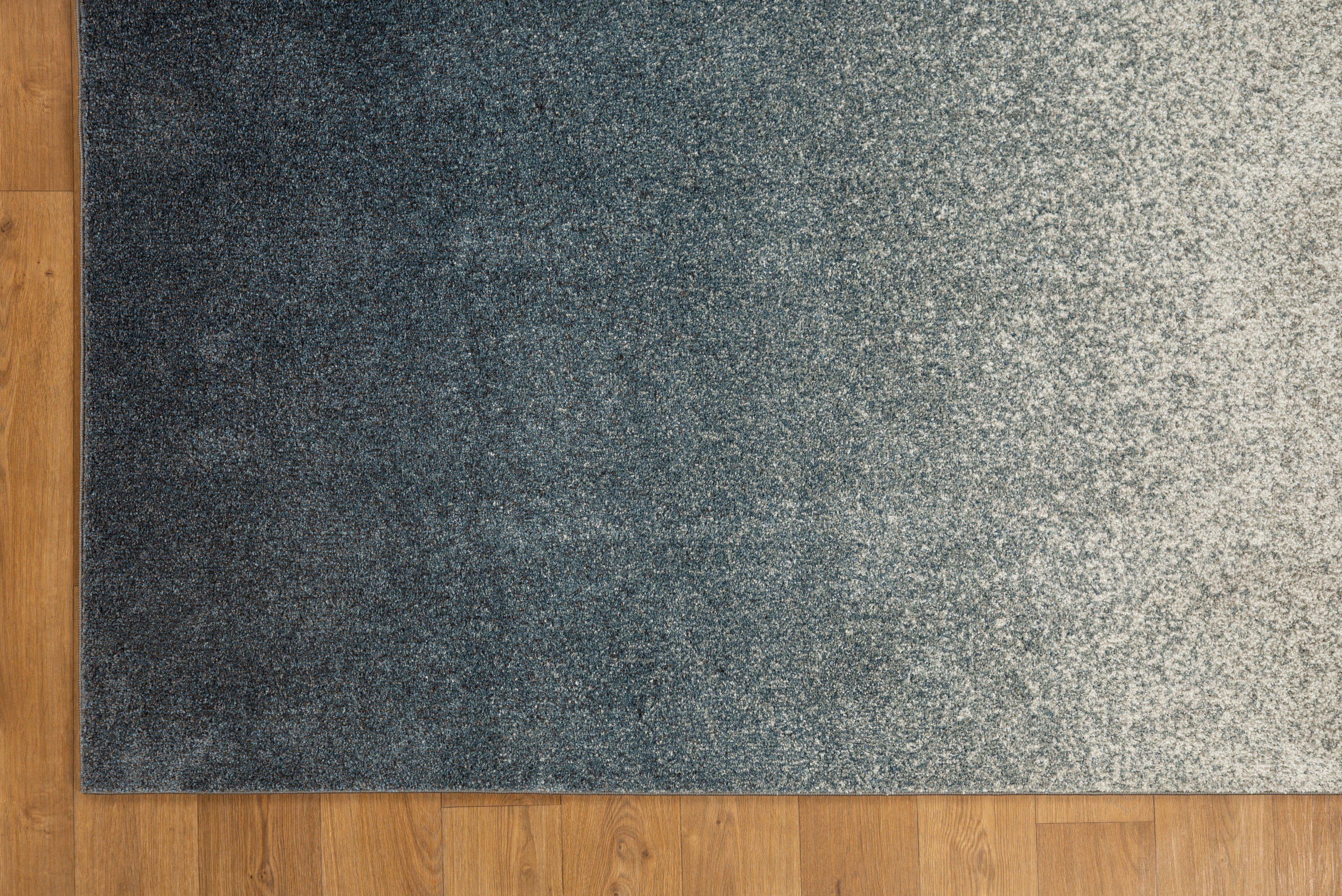 Dark grey to light grey ombre wool rug with speckled texture