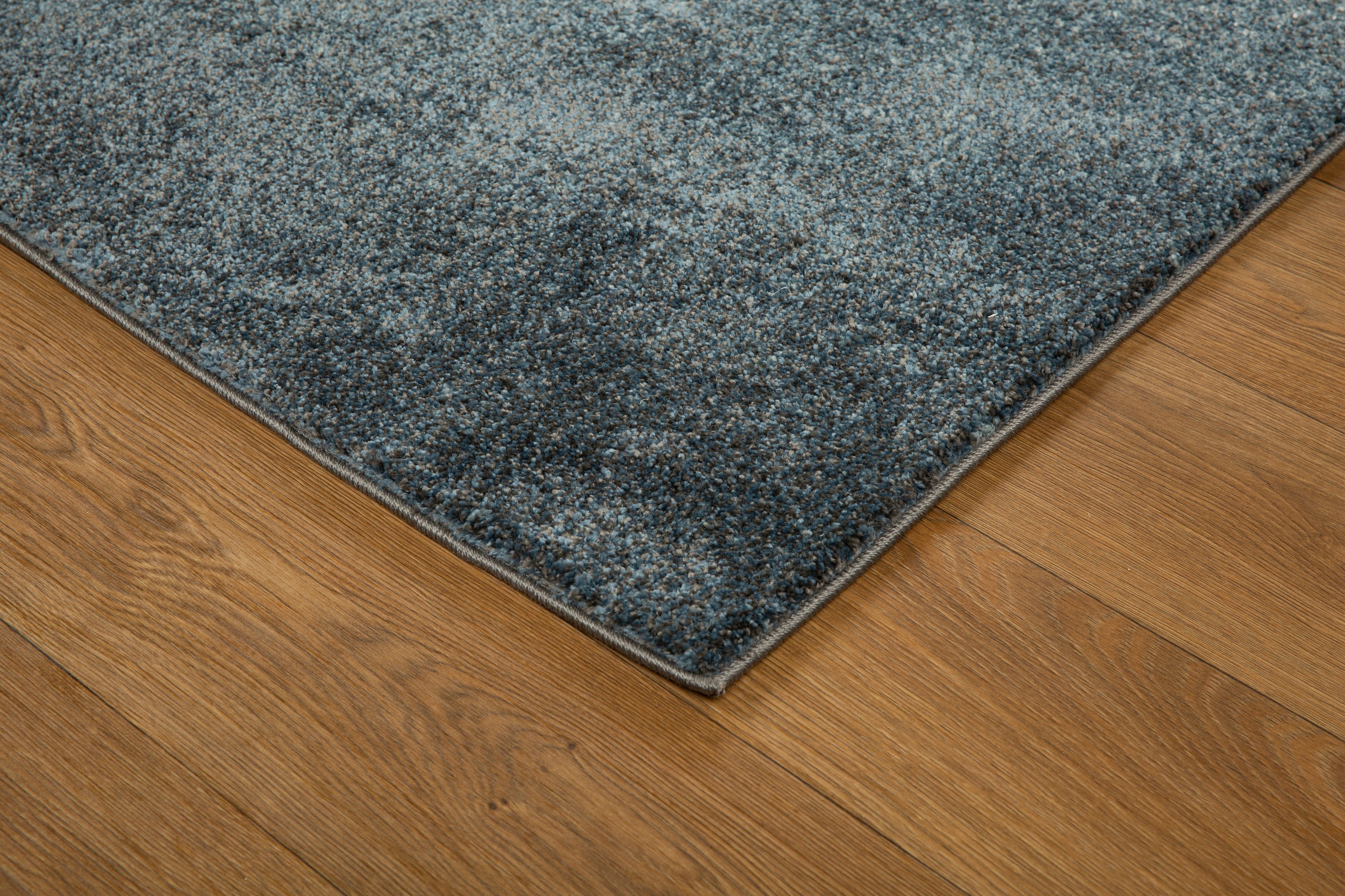 Dark grey to light grey ombre wool rug with speckled texture