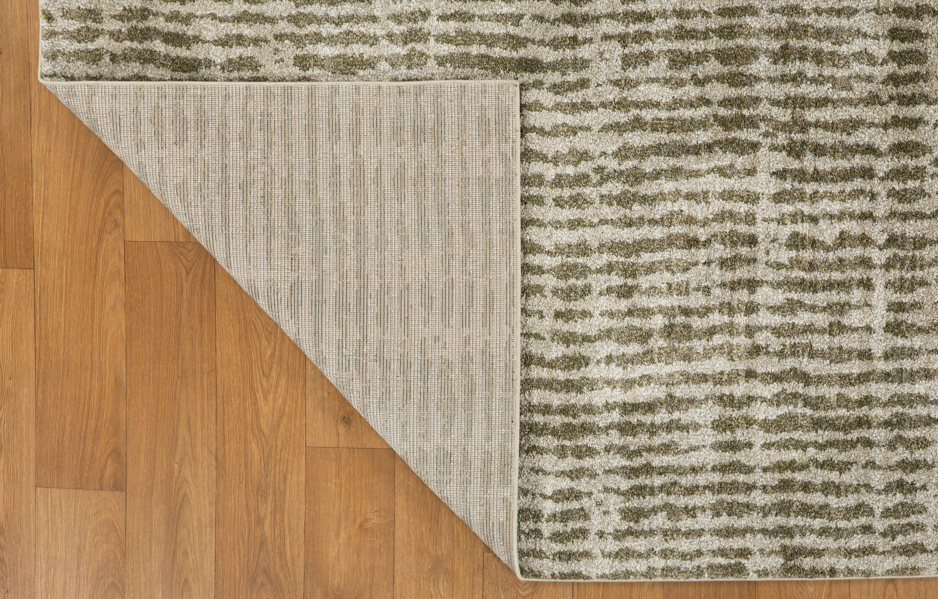 Neutral textured area rug with vertical striped pattern in beige and green tones