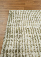 Neutral textured area rug with vertical striped pattern in beige and green tones