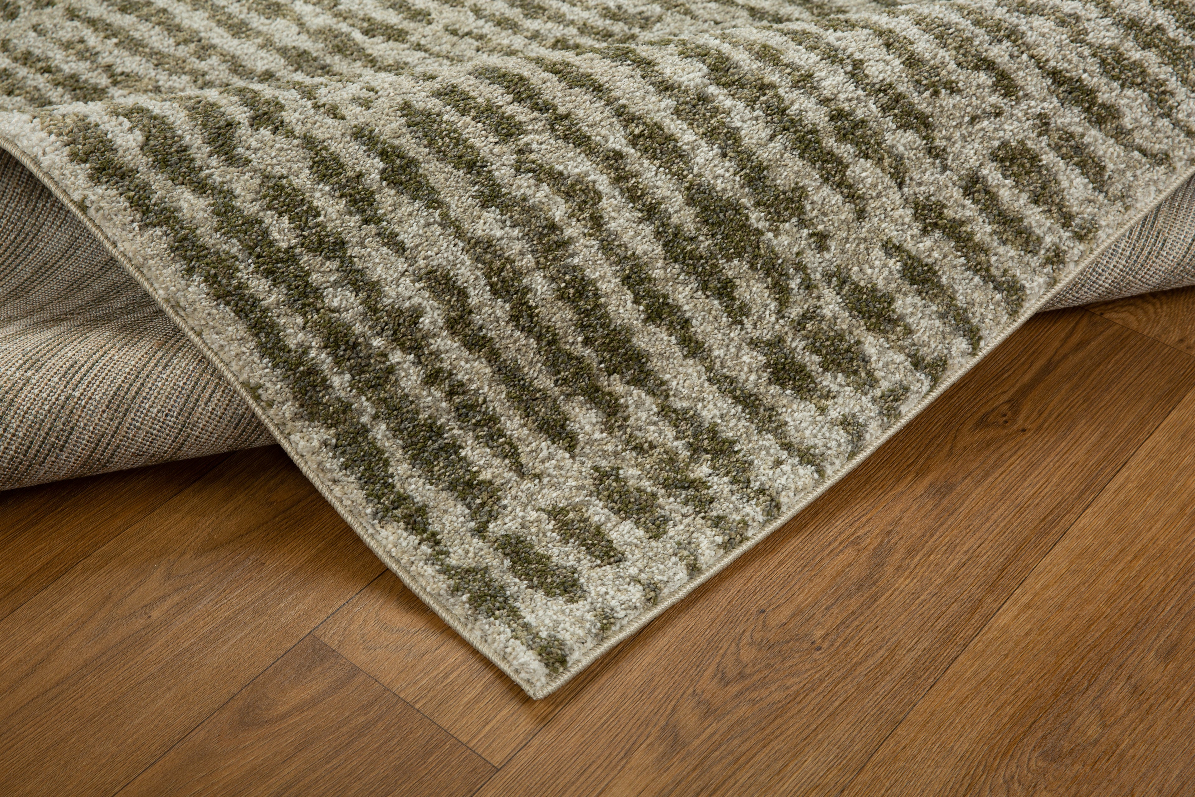 Neutral textured area rug with vertical striped pattern in beige and green tones