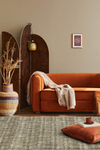 Neutral textured area rug with vertical striped pattern in beige and green tones