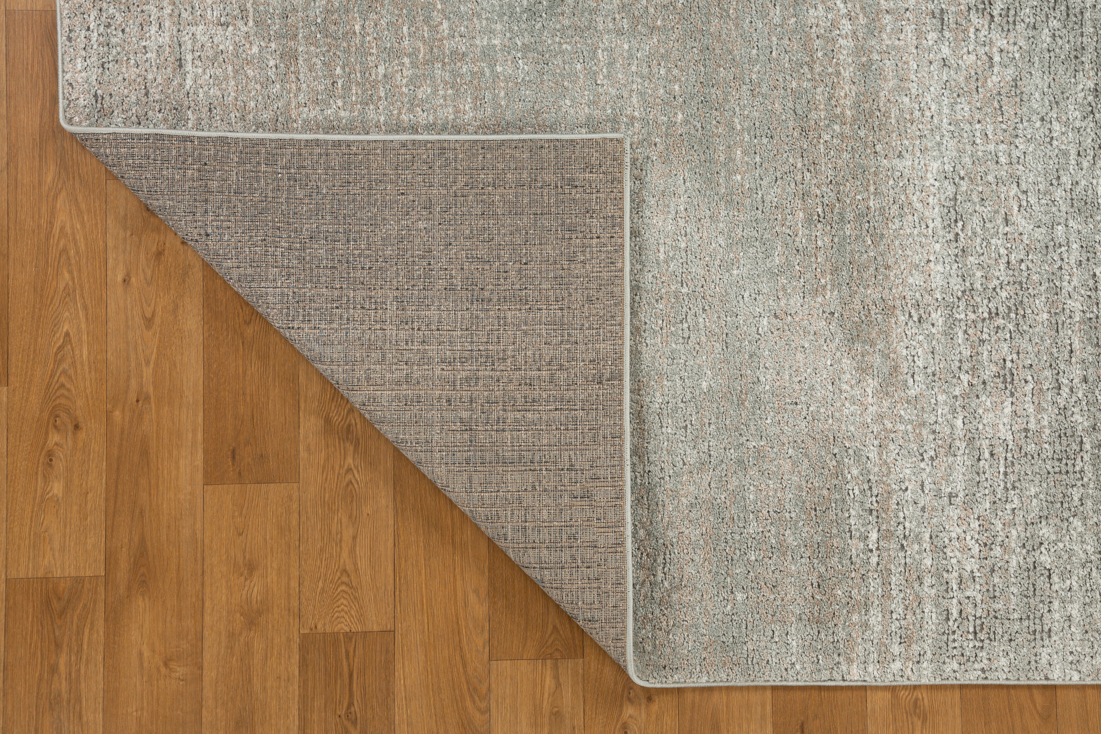 Neutral beige textured area rug with subtle geometric pattern and soft finish