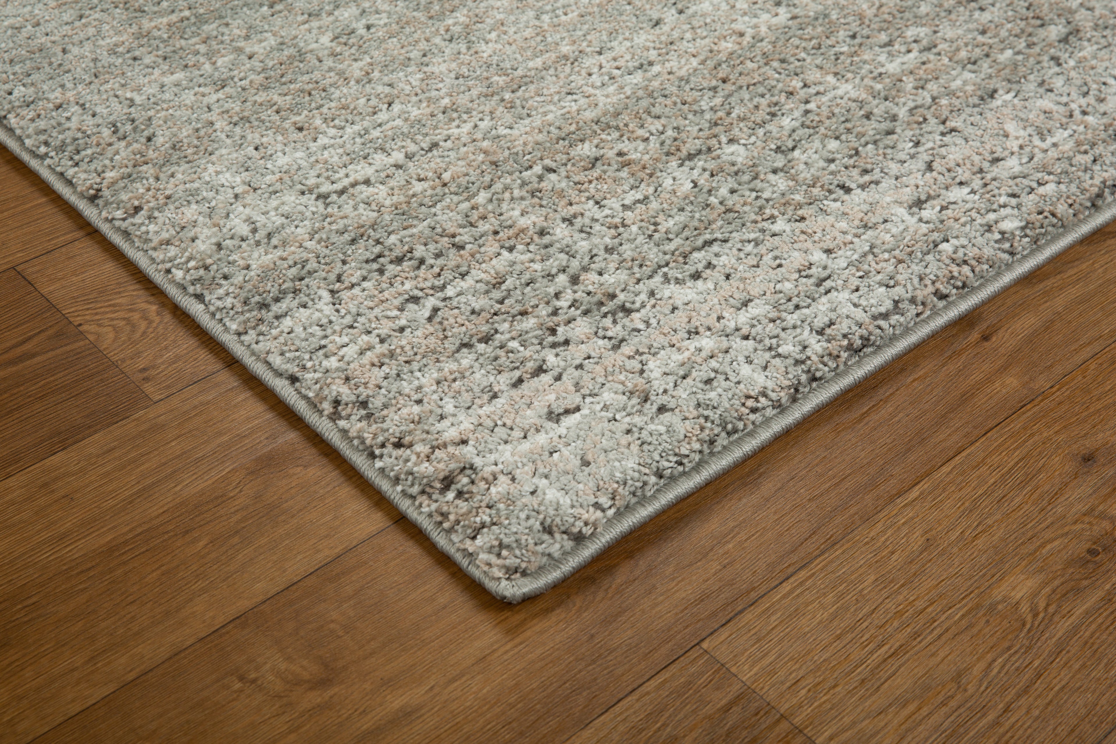 Neutral beige textured area rug with subtle geometric pattern and soft finish