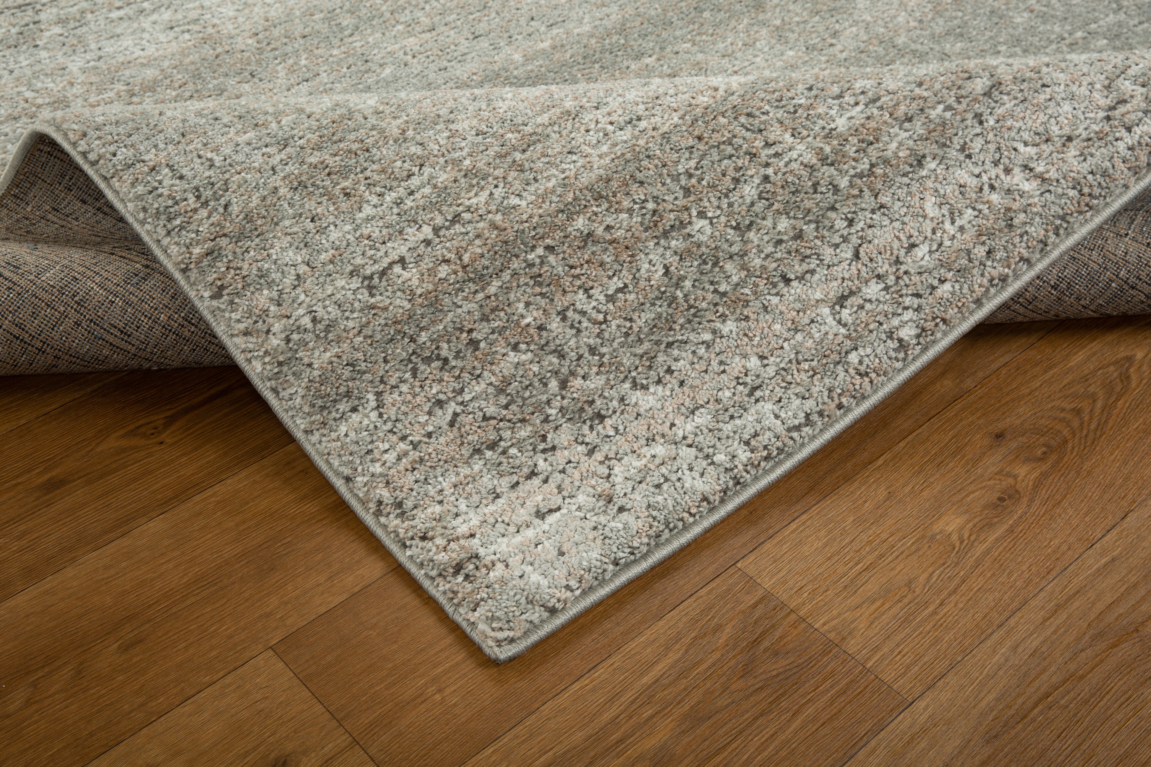 Neutral beige textured area rug with subtle geometric pattern and soft finish