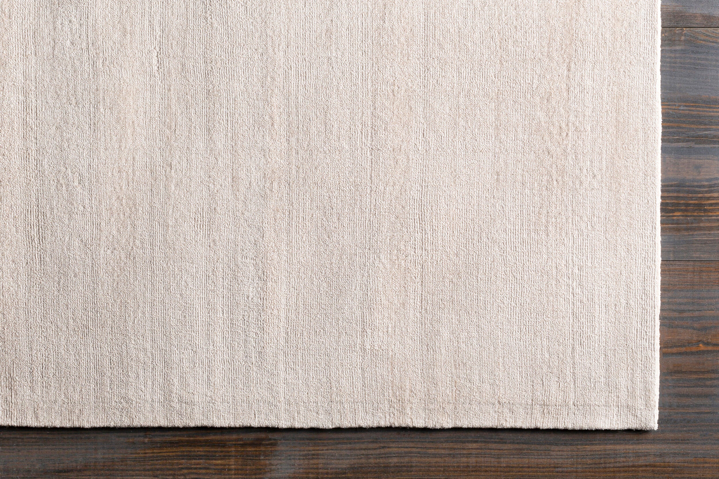 Soft beige wool rug with subtle woven texture and natural fibers