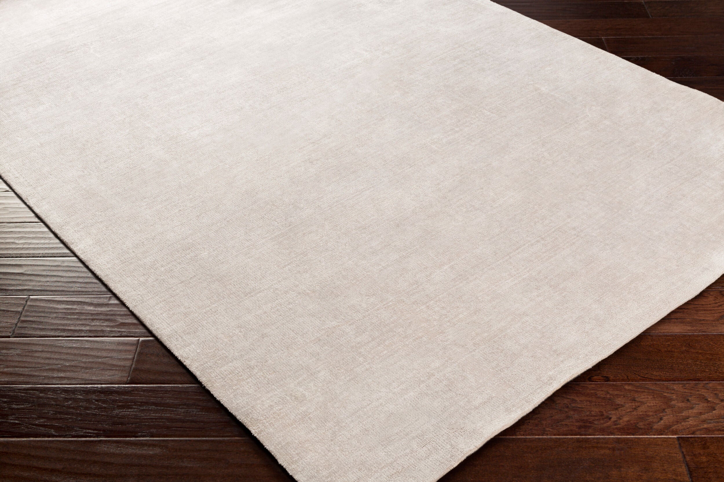 Soft beige wool rug with subtle woven texture and natural fibers