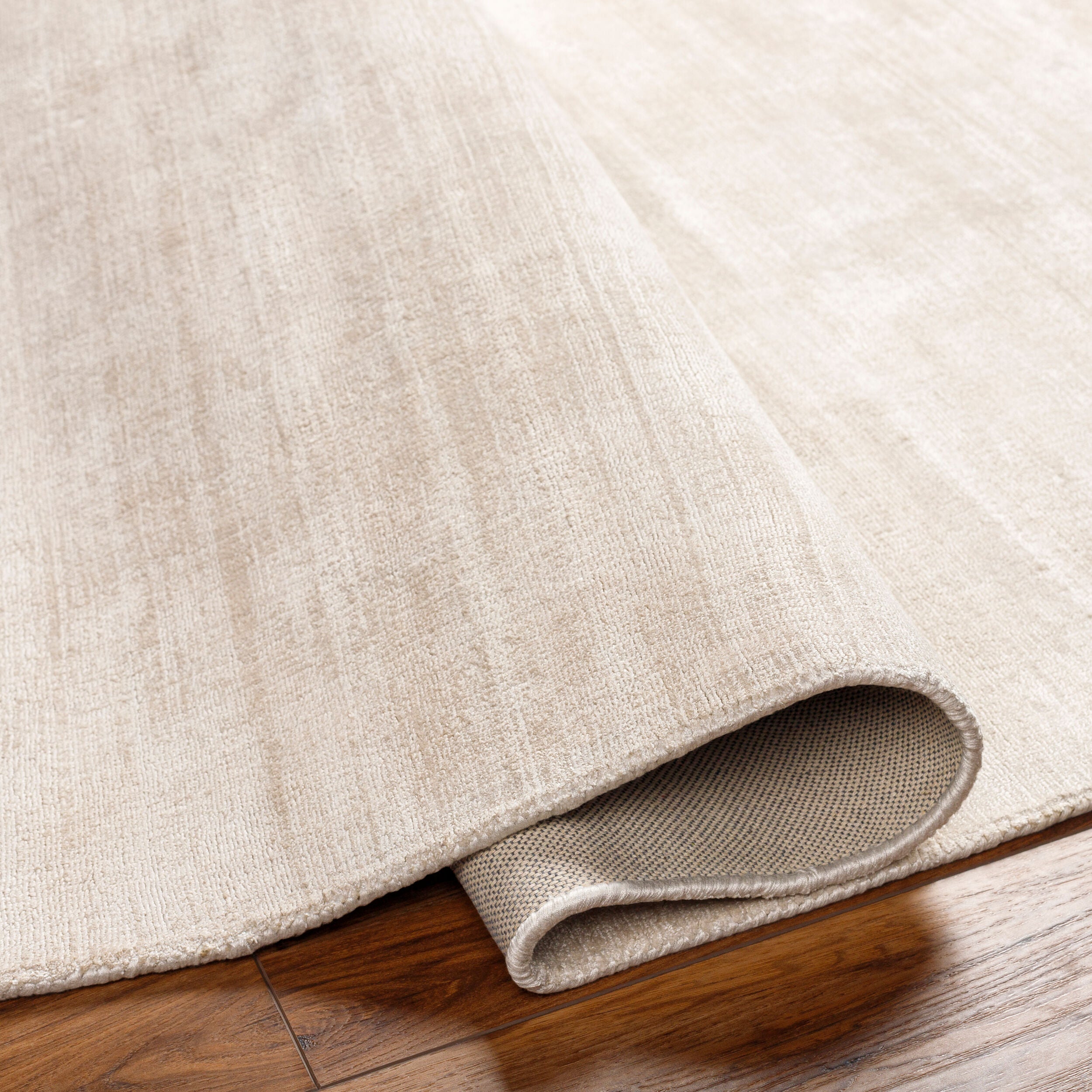 Soft beige wool rug with subtle woven texture and natural fibers