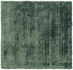 Sage green distressed rug with textured, mottled surface and worn vintage appearance