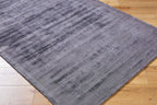 Grey distressed texture rug with subtle worn pattern and matte finish