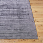 Grey distressed texture rug with subtle worn pattern and matte finish