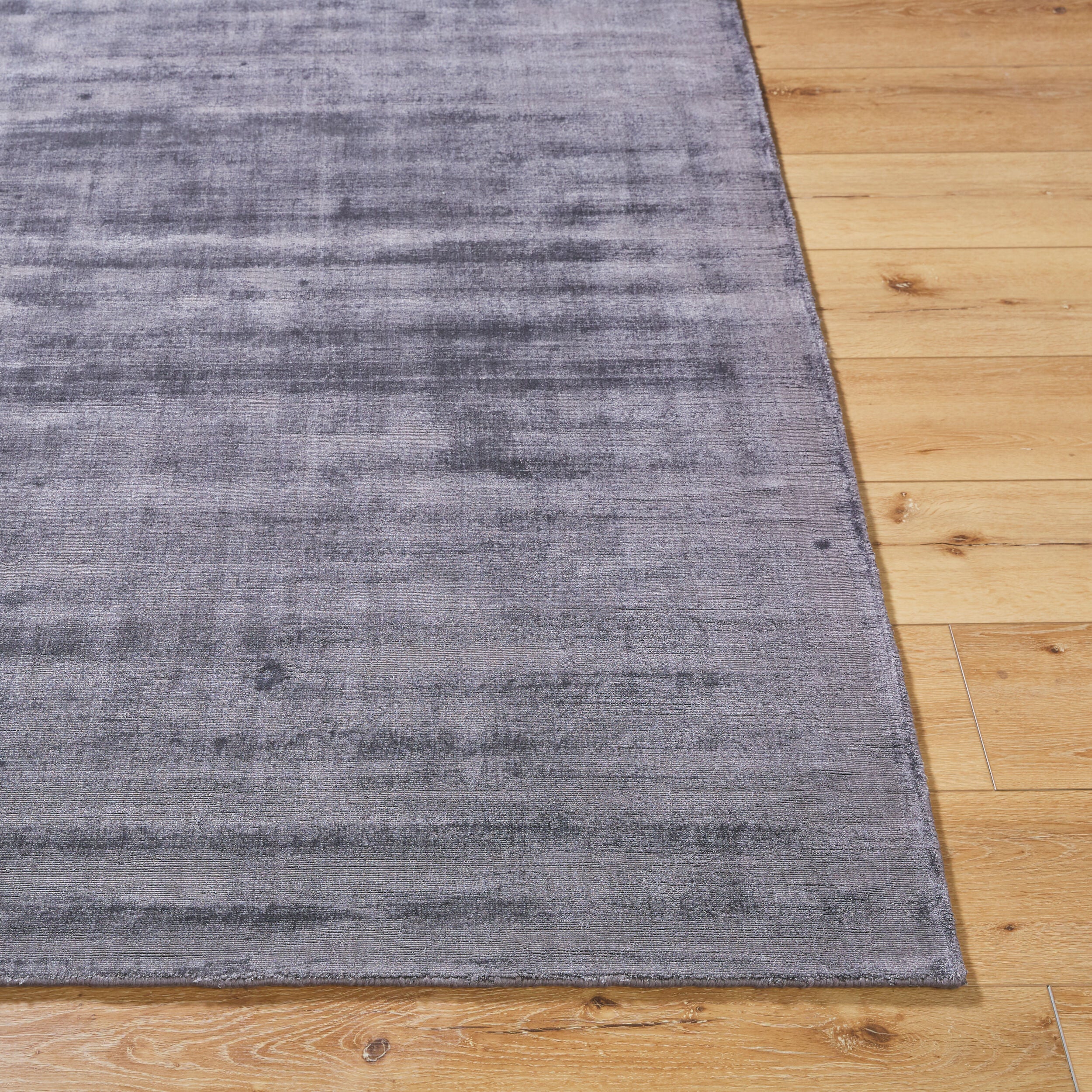 Grey distressed texture rug with subtle worn pattern and matte finish