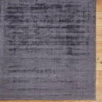 Grey distressed texture rug with subtle worn pattern and matte finish