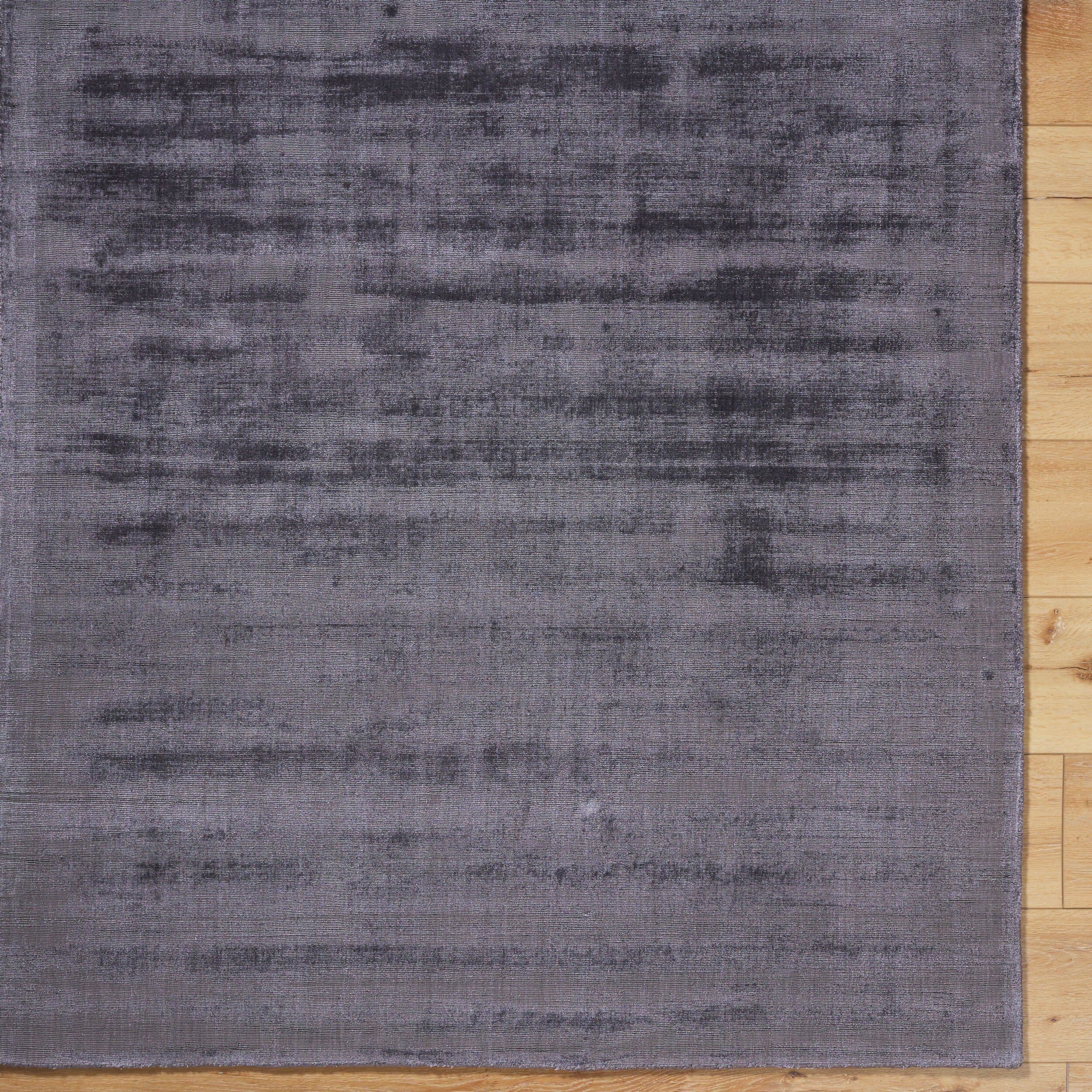 Grey distressed texture rug with subtle worn pattern and matte finish