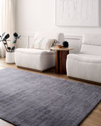 Grey distressed texture rug with subtle worn pattern and matte finish