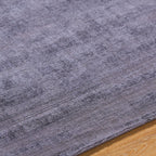 Grey distressed texture rug with subtle worn pattern and matte finish