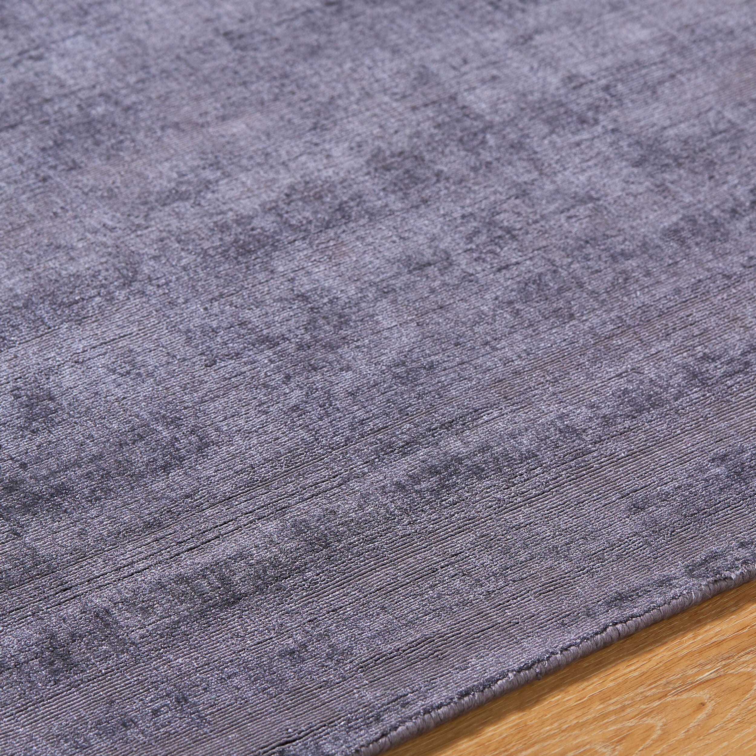 Grey distressed texture rug with subtle worn pattern and matte finish