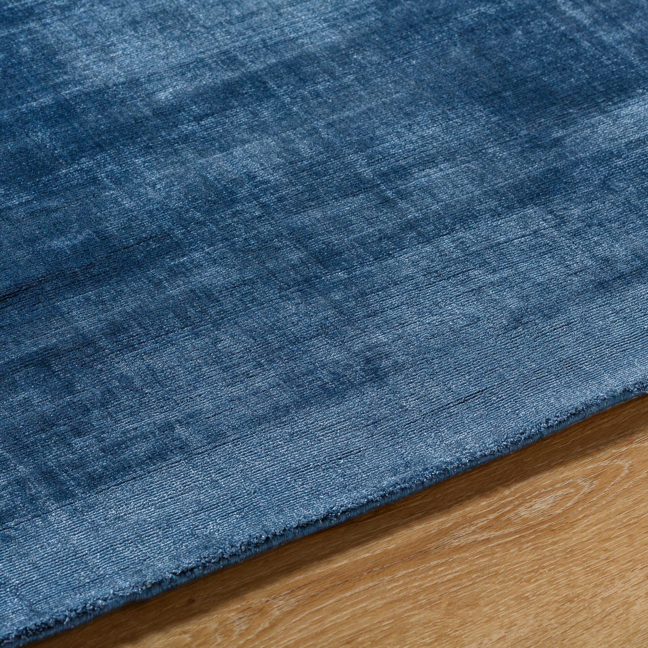 Blue distressed vintage style rug with textured woven pattern throughout